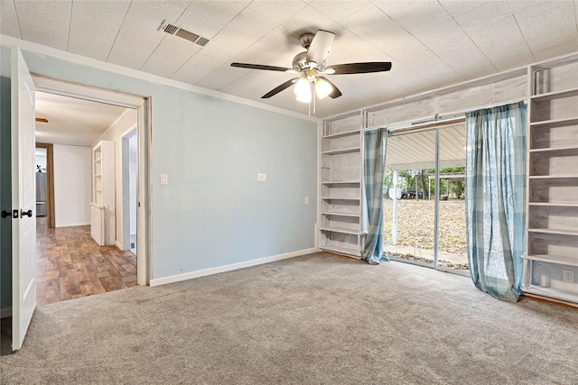 carpeted spare room featuring ceiling fan and crown molding