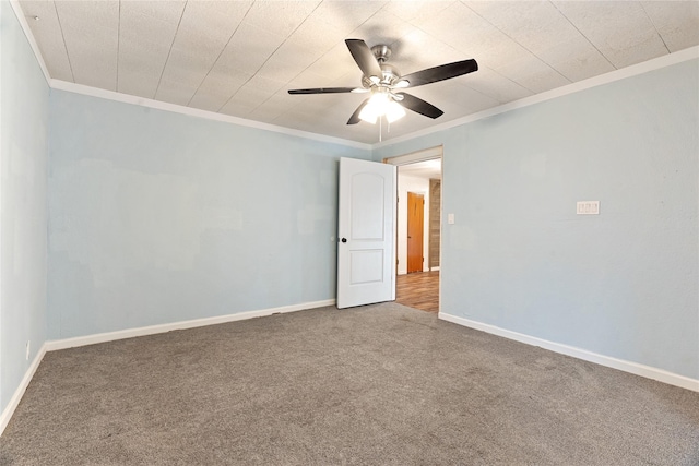 spare room with carpet flooring, ceiling fan, and crown molding