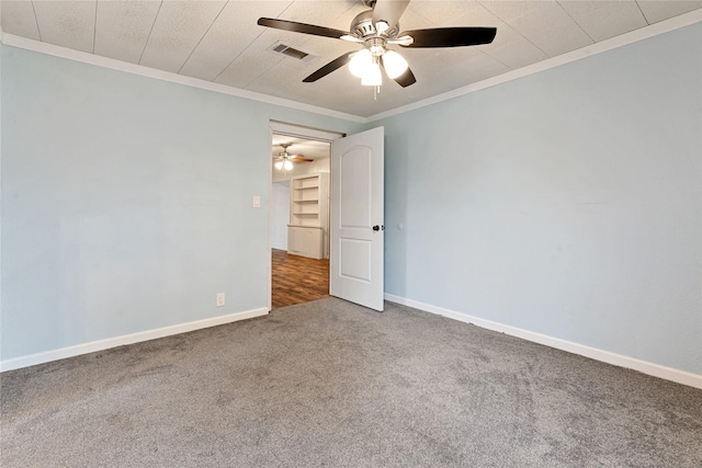 spare room featuring ceiling fan, carpet floors, and ornamental molding