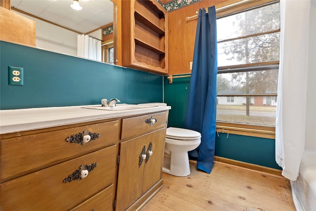 bathroom featuring hardwood / wood-style floors, plenty of natural light, toilet, and vanity