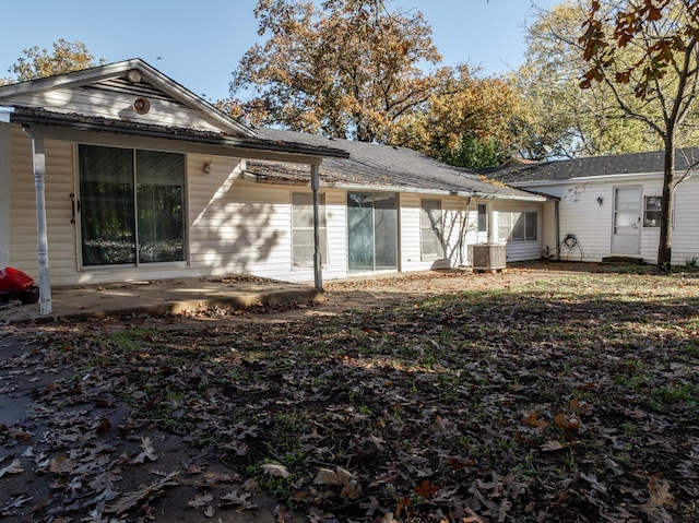 rear view of property featuring a patio and cooling unit