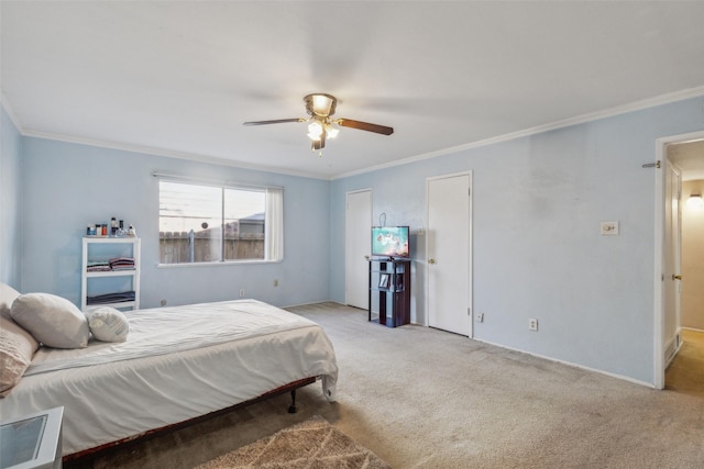 carpeted bedroom featuring ceiling fan and crown molding