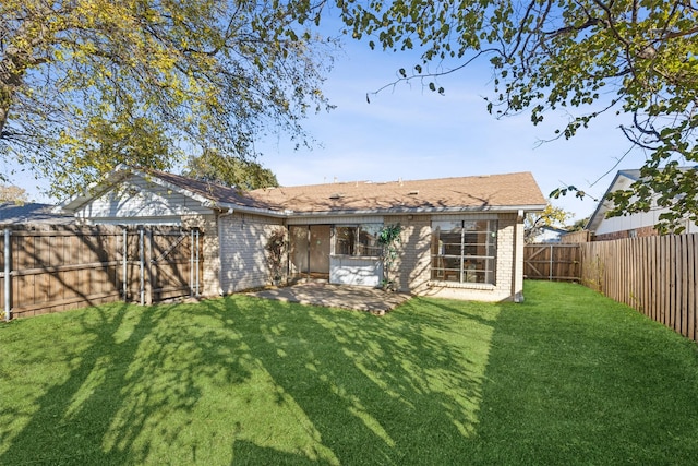 back of house with a yard and a patio area