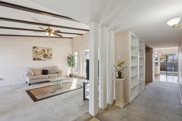 hall featuring lofted ceiling with beams and light colored carpet