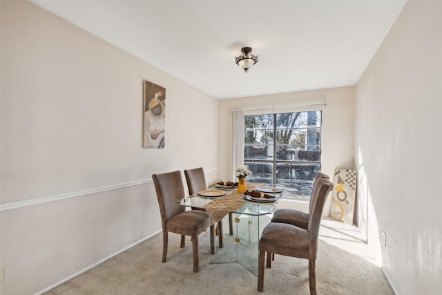 dining room featuring light colored carpet