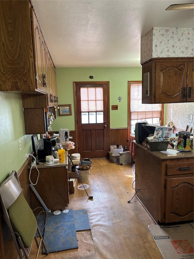 kitchen with wooden walls and a textured ceiling