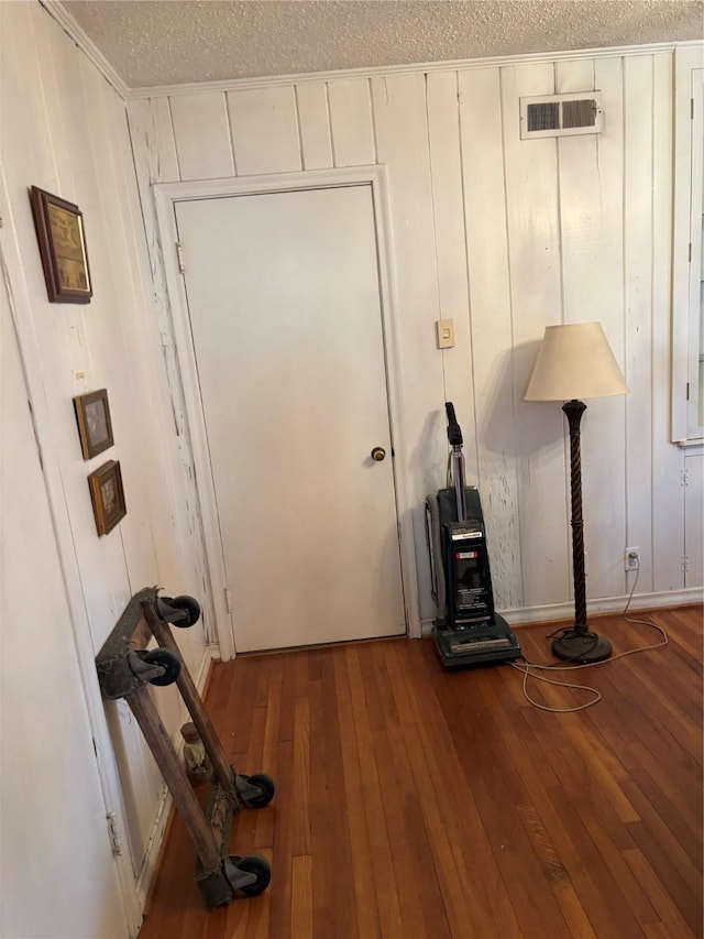 interior space with wood-type flooring and a textured ceiling