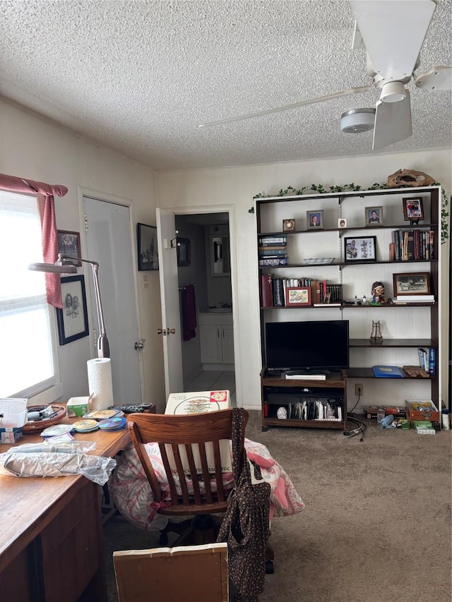 office featuring ceiling fan, carpet flooring, and a textured ceiling