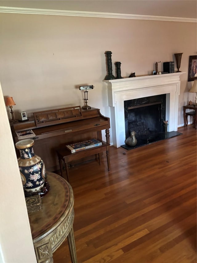 living room with crown molding and dark wood-type flooring