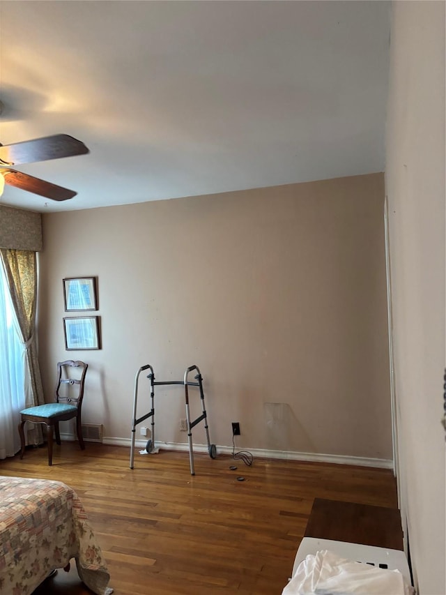 bedroom with ceiling fan and hardwood / wood-style floors