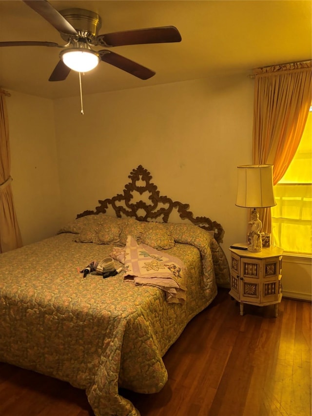 bedroom featuring ceiling fan and dark hardwood / wood-style flooring