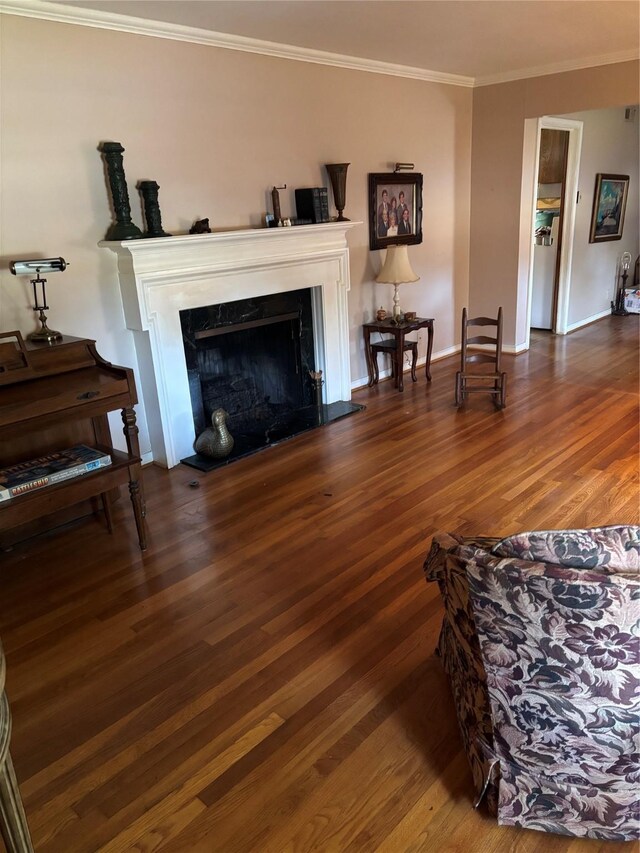 living room with hardwood / wood-style flooring and crown molding