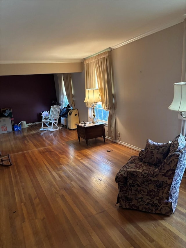 sitting room with crown molding and hardwood / wood-style flooring