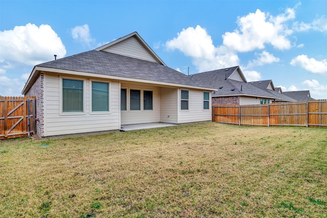 rear view of property featuring a patio area and a lawn