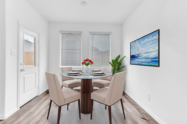 dining space featuring light wood-type flooring and a wealth of natural light