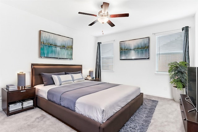 bedroom with ceiling fan and light colored carpet