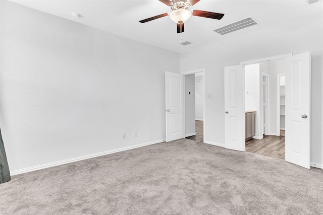 unfurnished bedroom featuring light colored carpet and ceiling fan