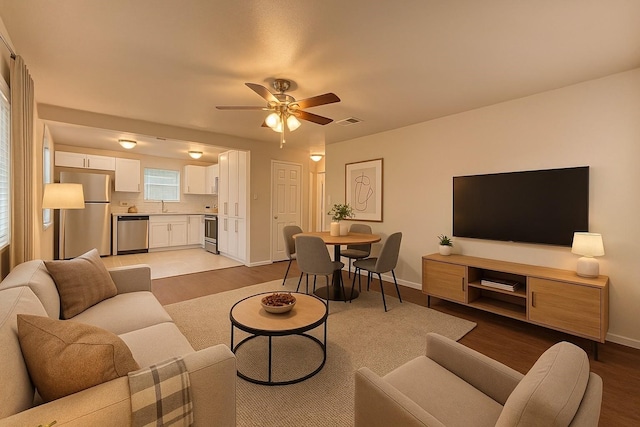 4613 Crenshaw Ave, Fort Worth, TX 76105 - living area with light wood-style floors, a ceiling fan, and baseboards