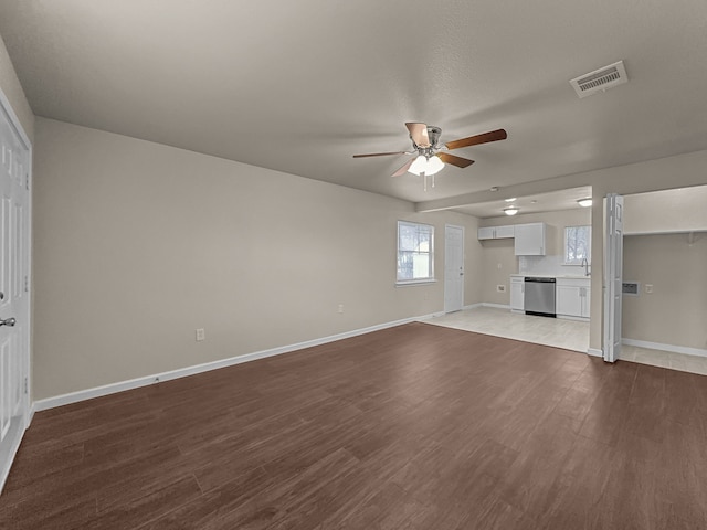 unfurnished living room with hardwood / wood-style floors and ceiling fan