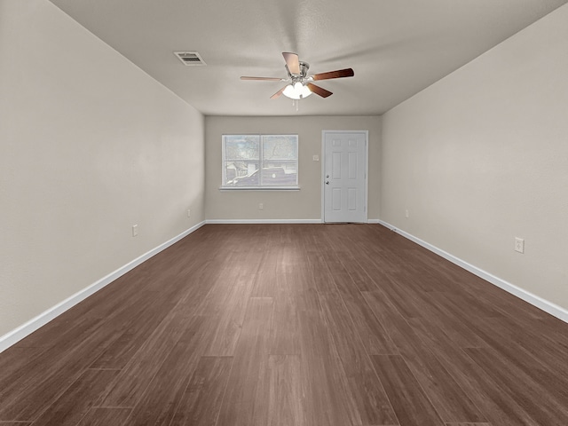 spare room featuring ceiling fan and dark hardwood / wood-style floors