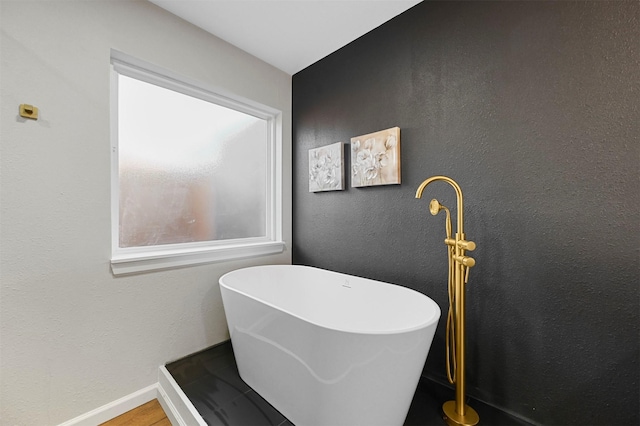 bathroom with a tub to relax in