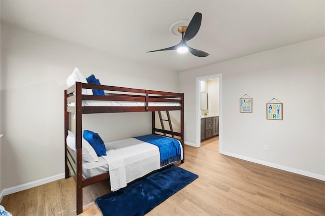 bedroom featuring ceiling fan, ensuite bathroom, and light hardwood / wood-style flooring