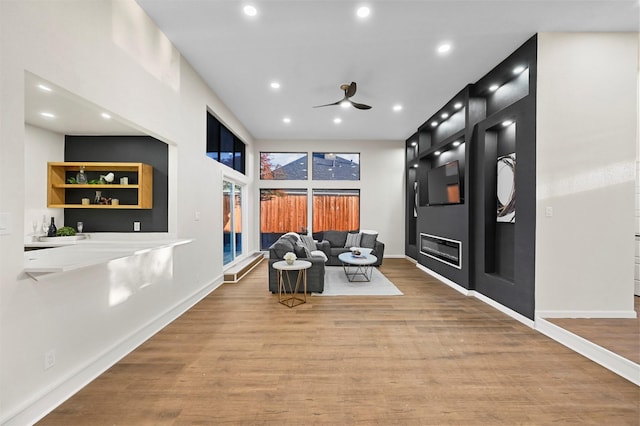 living area with ceiling fan and light wood-type flooring