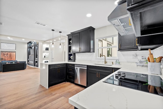 kitchen with sink, dishwasher, hanging light fixtures, backsplash, and light hardwood / wood-style floors