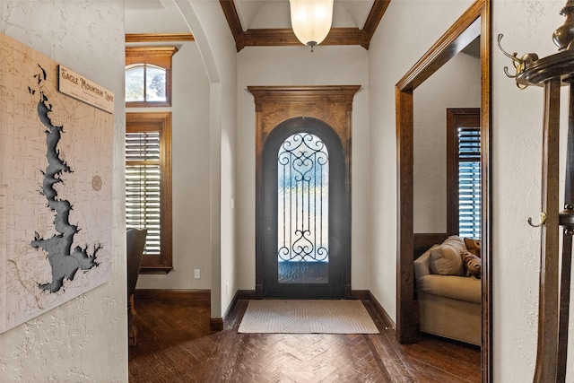 entrance foyer with crown molding and dark parquet floors