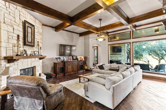 living room featuring a fireplace, wood-type flooring, ceiling fan, and beam ceiling