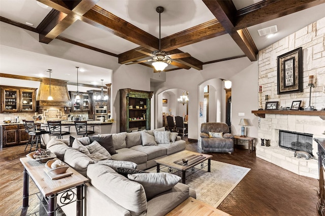 living room featuring a fireplace, beamed ceiling, dark wood-type flooring, and coffered ceiling