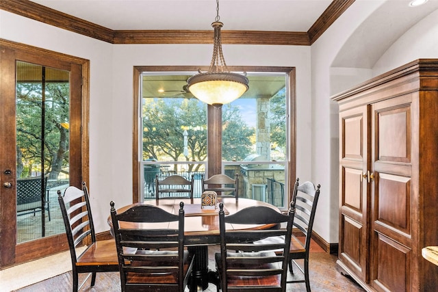 dining area featuring ornamental molding and light wood-type flooring