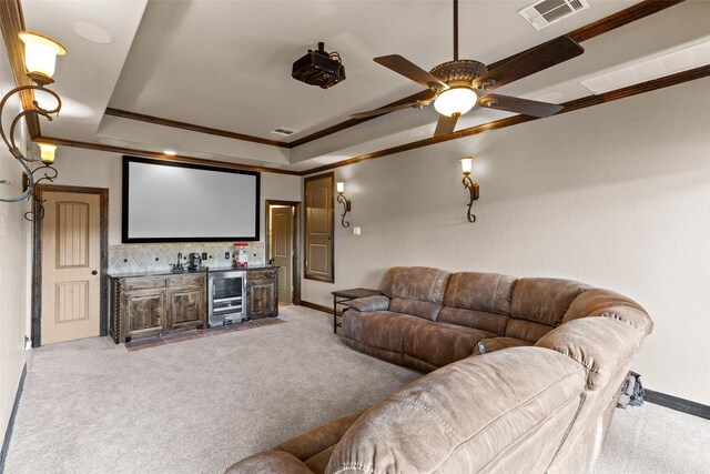 carpeted home theater room featuring ceiling fan, crown molding, wine cooler, and indoor bar