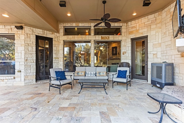 view of patio / terrace featuring heating unit, ceiling fan, and an outdoor hangout area