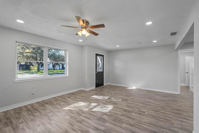 interior space featuring wood-type flooring, a textured ceiling, and ceiling fan