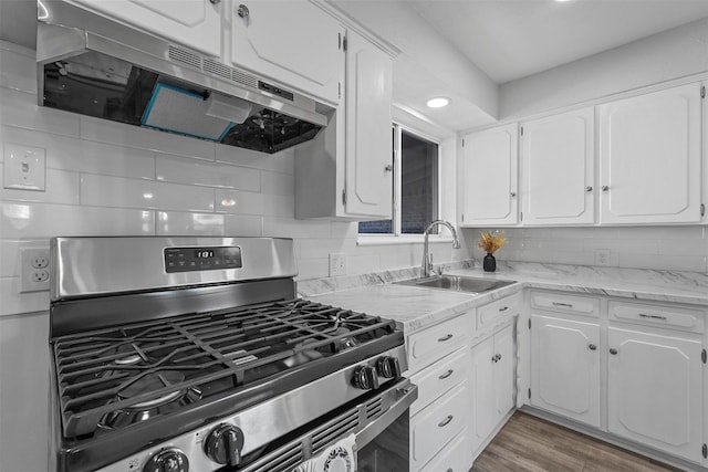 kitchen with sink, white cabinets, and stainless steel gas range