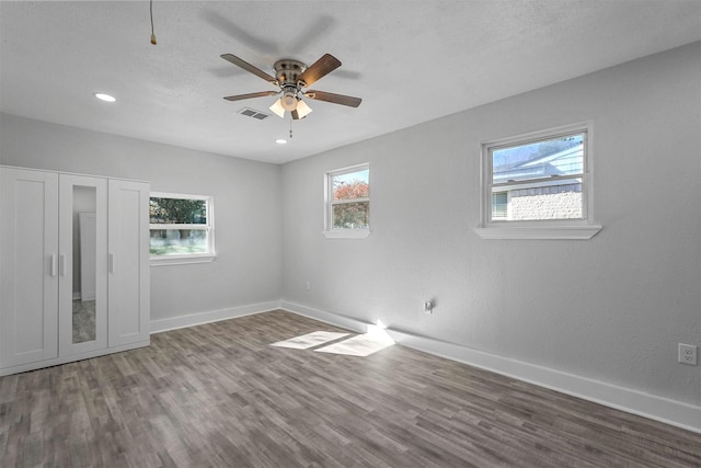 spare room with hardwood / wood-style floors and ceiling fan