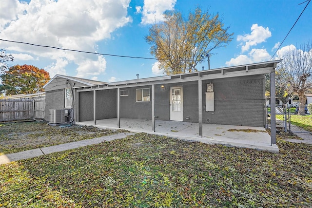 rear view of house with central air condition unit and a patio