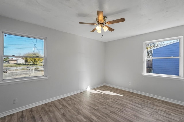 spare room featuring hardwood / wood-style floors and ceiling fan