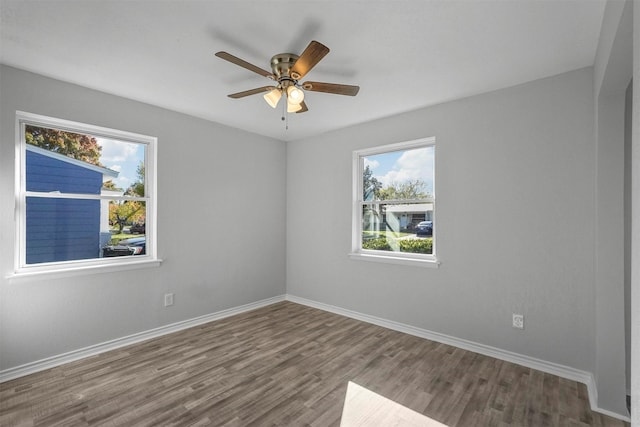 unfurnished room featuring a wealth of natural light, ceiling fan, and hardwood / wood-style flooring