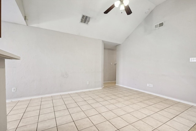 spare room featuring ceiling fan, light tile patterned flooring, and vaulted ceiling