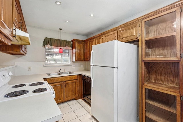 kitchen with light tile patterned flooring, pendant lighting, white appliances, and sink