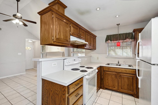 kitchen with white appliances, sink, hanging light fixtures, vaulted ceiling, and light tile patterned floors