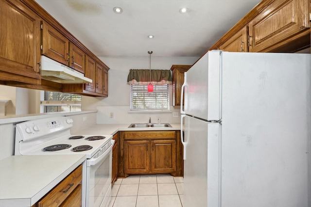 kitchen with pendant lighting, white appliances, sink, and light tile patterned floors