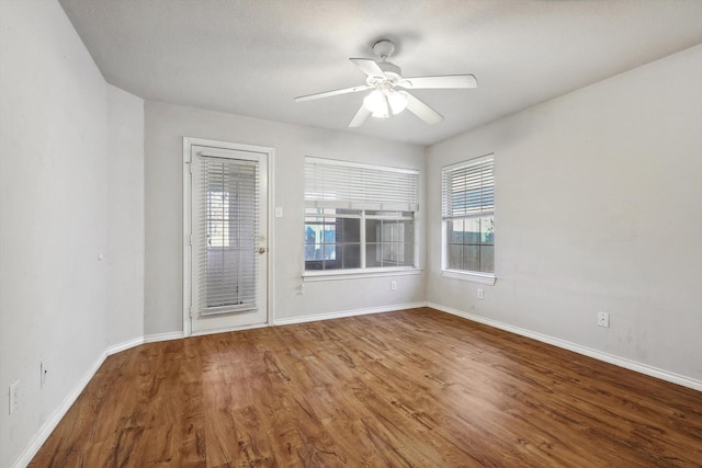 spare room featuring ceiling fan and hardwood / wood-style floors