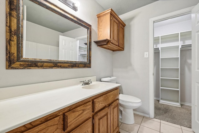 bathroom featuring tile patterned floors, vanity, and toilet