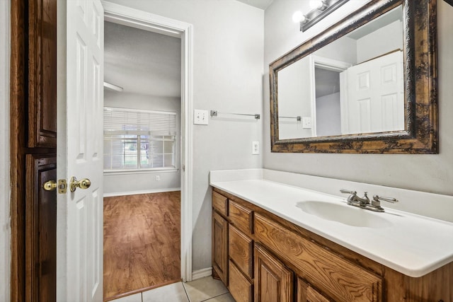 bathroom with tile patterned flooring, vanity, and a textured ceiling