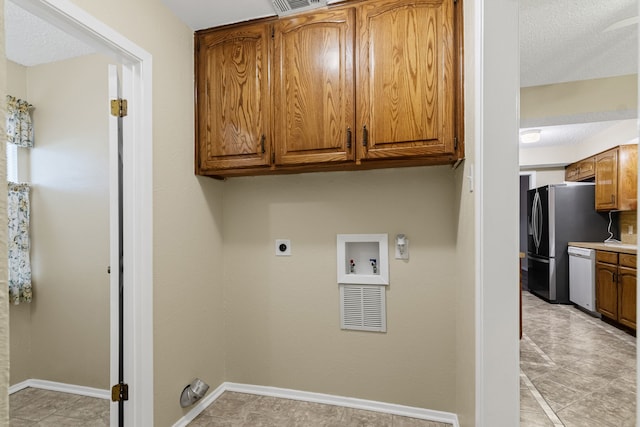 clothes washing area featuring cabinets, hookup for a washing machine, light tile patterned floors, and electric dryer hookup