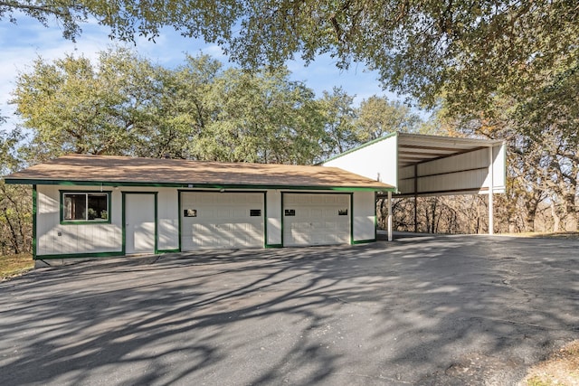 view of outbuilding with a carport and a garage