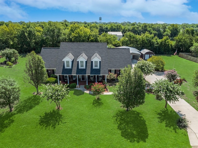 birds eye view of property with a view of trees